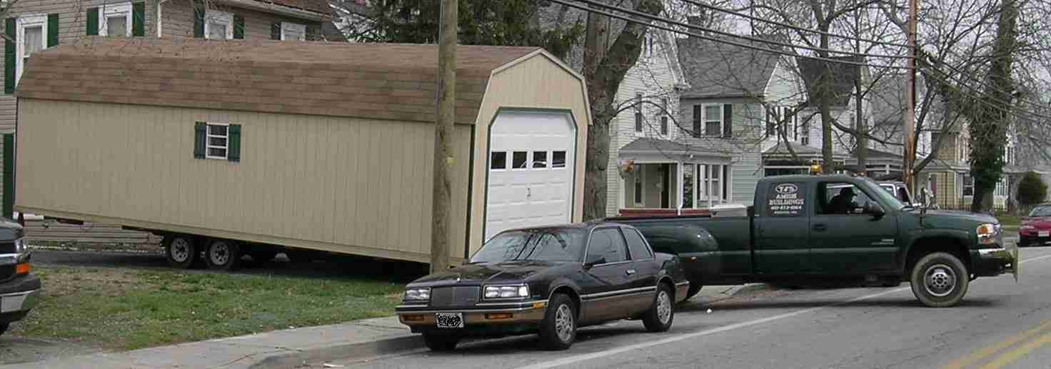 Dutch Barn Garage being backed into a driveway for delivery Dutch Barn Garage being backed into a driveway